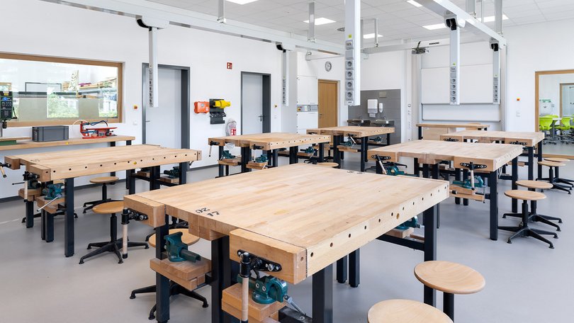Workshop classroom with wooden workbenches and tools