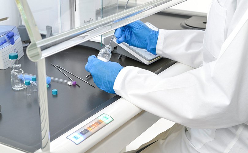 Person performs laboratory work in the AKKURAT safety balance cabinet
