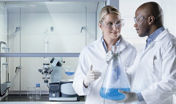 Lab staff working in front of a fume hood