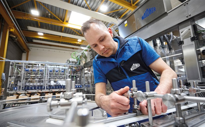 Service technician performs maintenance work on a machine