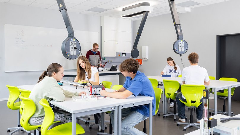 Students working on projects in a modern classroom environment