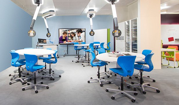 Flexible learning room with blue chairs and monitor
