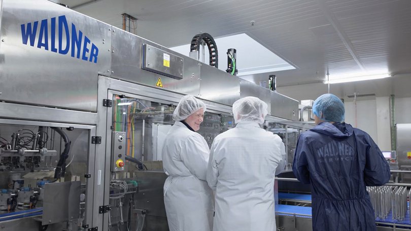 Employees monitor production plant