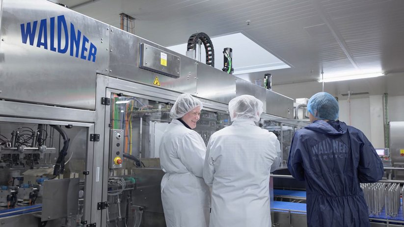 Employees monitor production plant