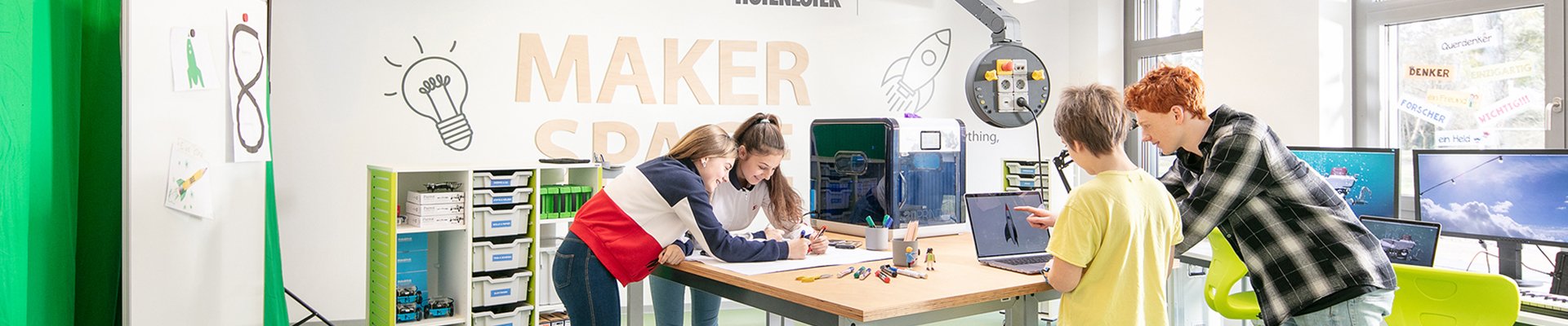 Students experimenting in a colorful makerspace with Fly One