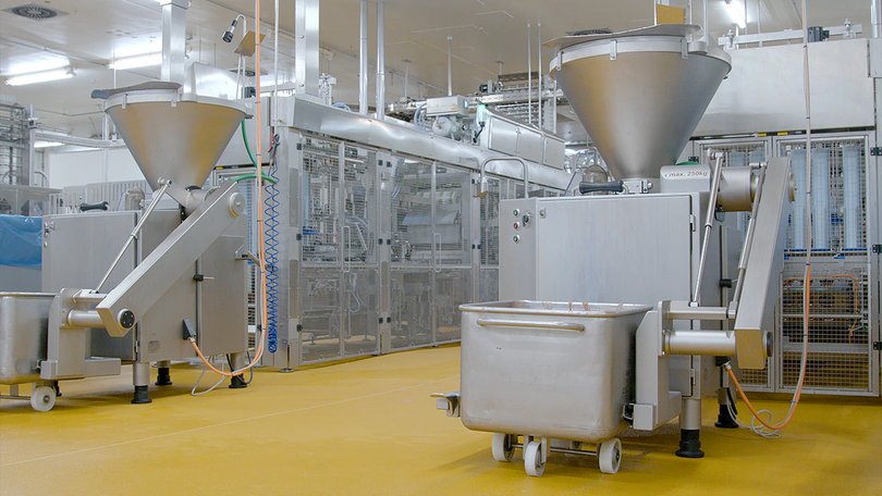 Production hall with equipment and material feed