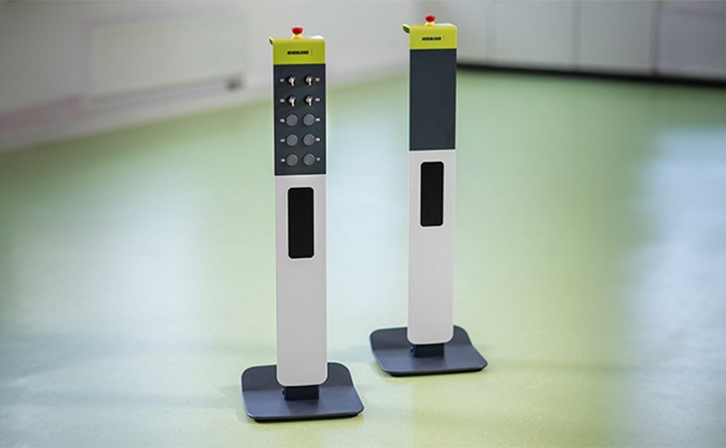 Two safety columns with emergency stop buttons and controls