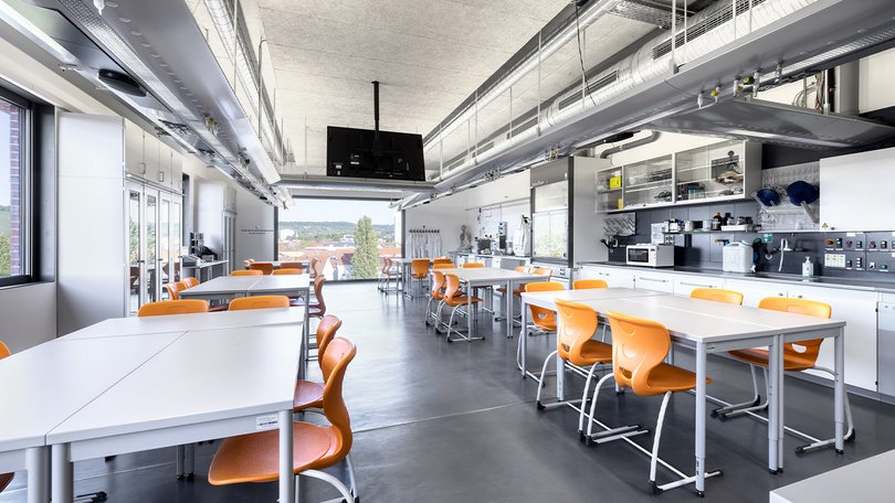 Bright lab with orange chairs and scientific equipment