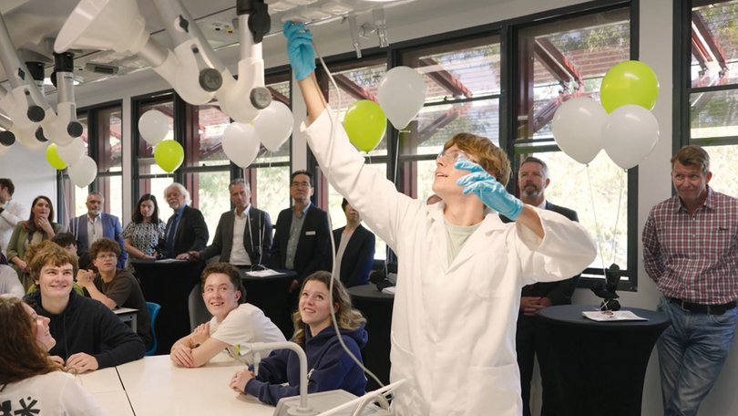 Person conducting experiment in front of an audience