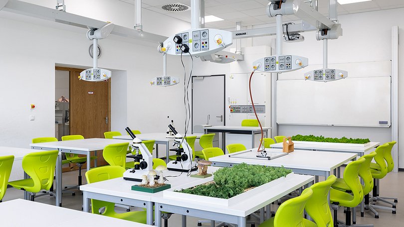 Biology classroom with plants and microscopes for experiments