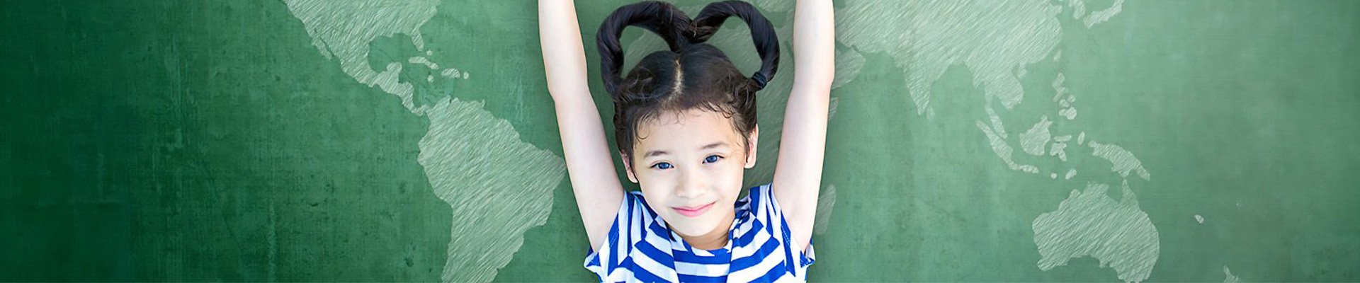 Child lying on a world map