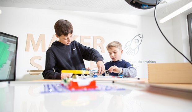 Students exploring a makerspace environment with creative materials