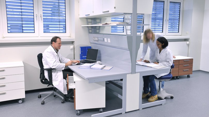 Scientists working at laboratory desks