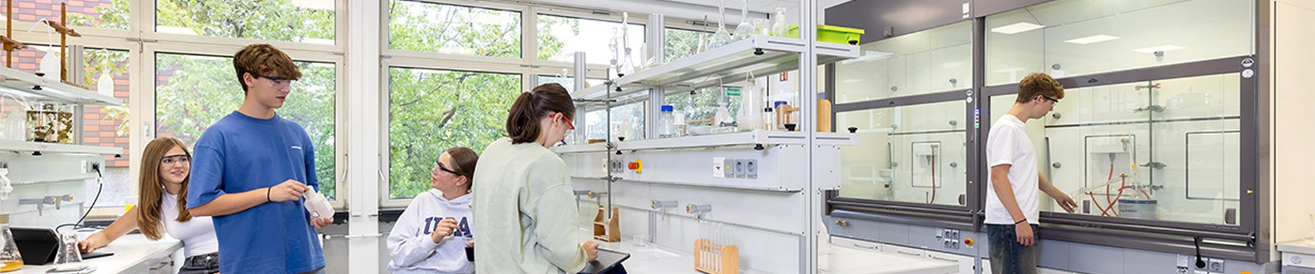 Students conducting science experiments in a bright laboratory