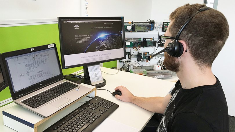 Person mit Headset arbeitet am Computer im Labor