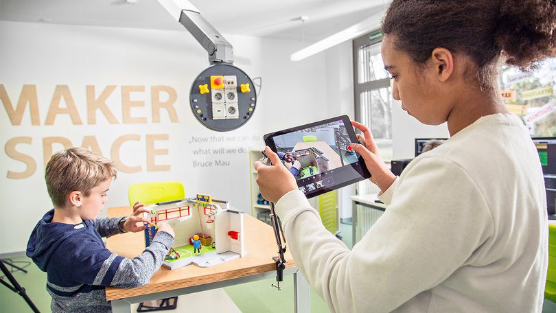 Students using tablets and programming devices in a makerspace