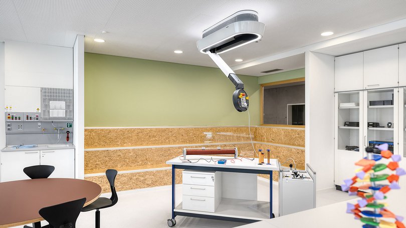 Bright science classroom with presentation area and lab tables