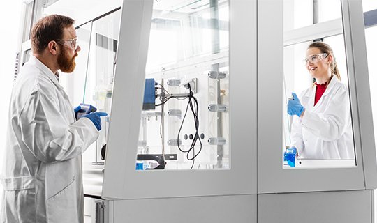 Laboratory staff working with fume hoods