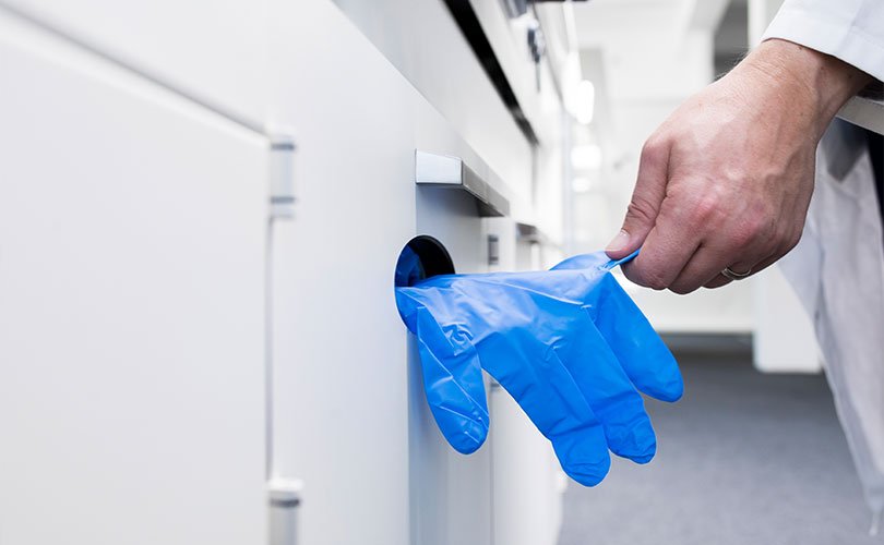 Laboratory hood with glove dispenser
