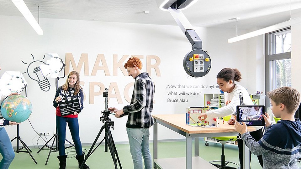 Students creating projects in a bright makerspace