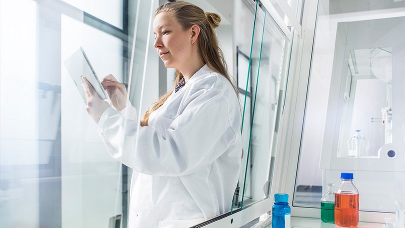 Laboratory technician at work on the fume hood