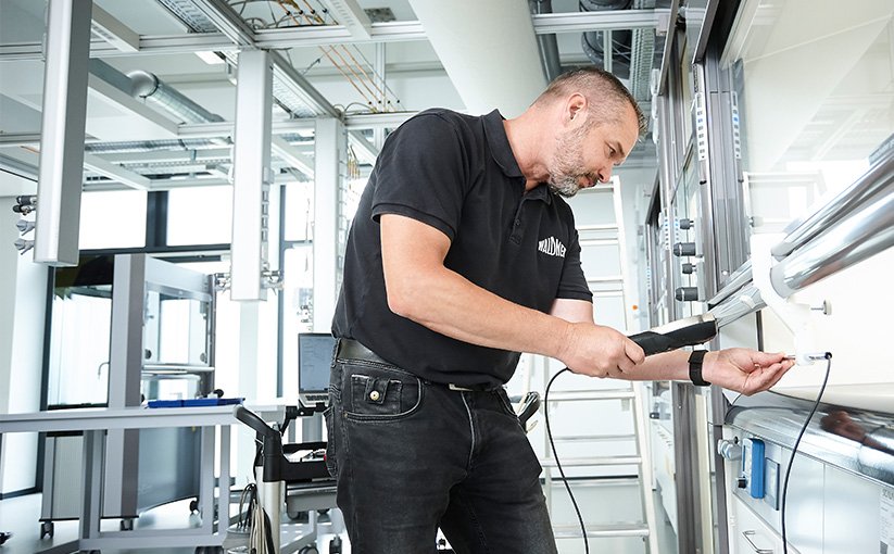 Person inspects equipment with technical device