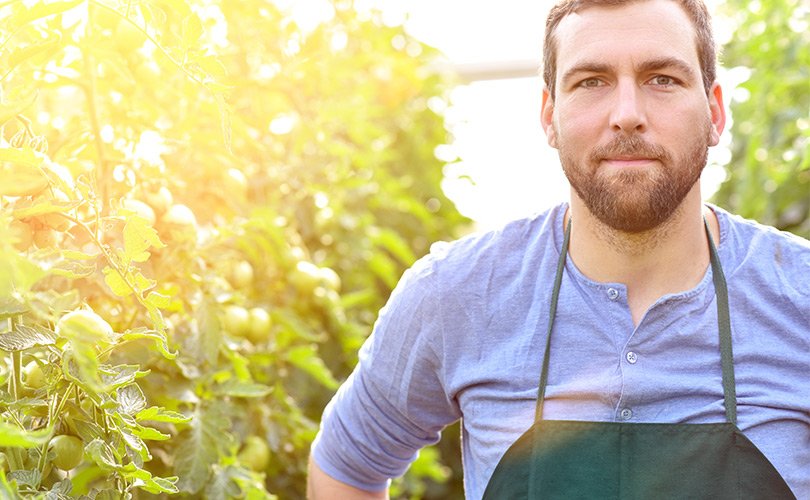 Man standing in front of a field